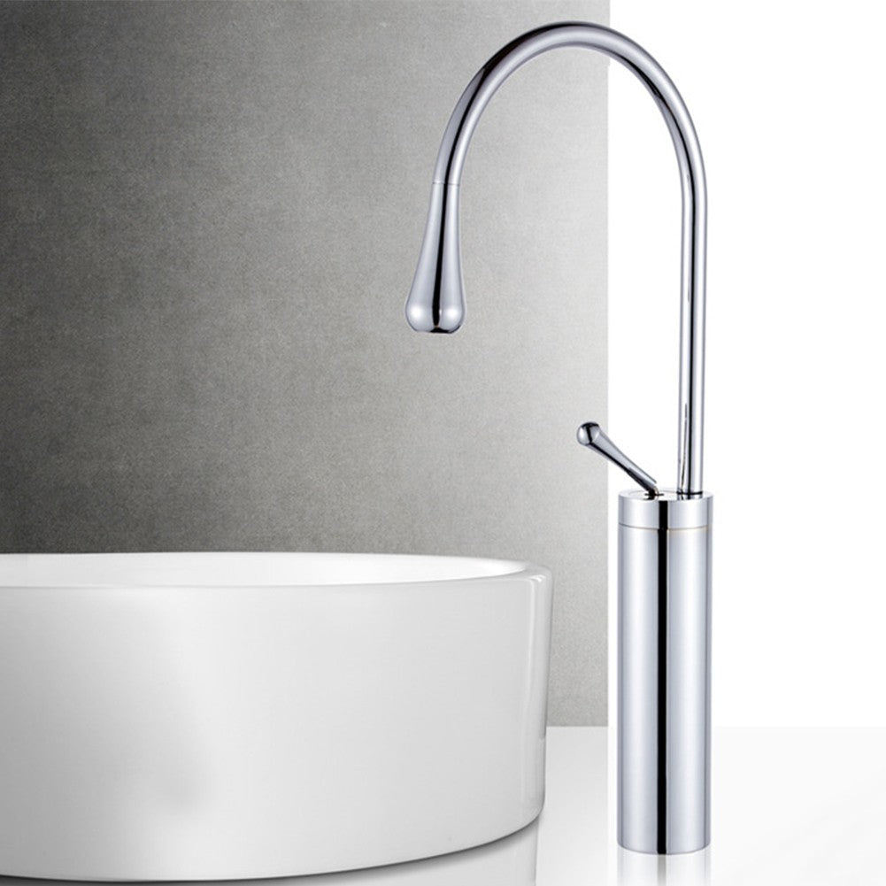 Chrome faucet mounted on a gray wall with a white sink below