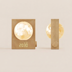 A wooden alarm clock and night light set shown on a warm beige background. The left unit has a square wood-grain body with a glowing moon lamp inside and a digital display showing 20:30.