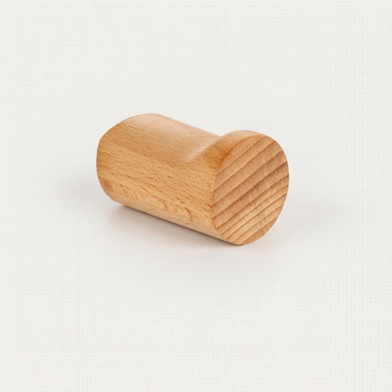 A small cylindrical wooden object with a smooth, rounded top and a ribbed side, shown on a plain light background.