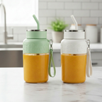Two colorful drink containers with straws on a kitchen counter.