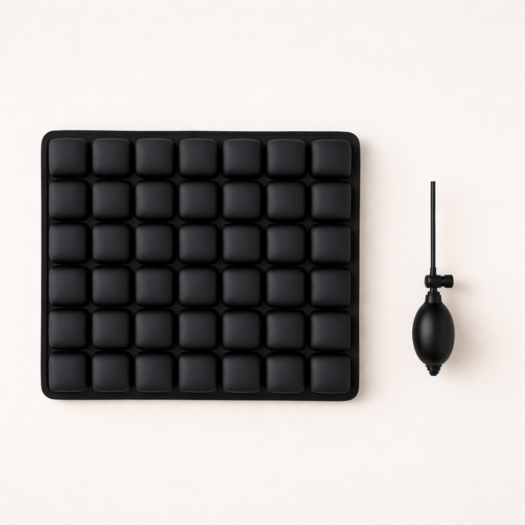 Black silicone ice cube tray with a black pump on a white background