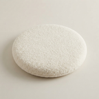 Round, textured white stone on a light beige background