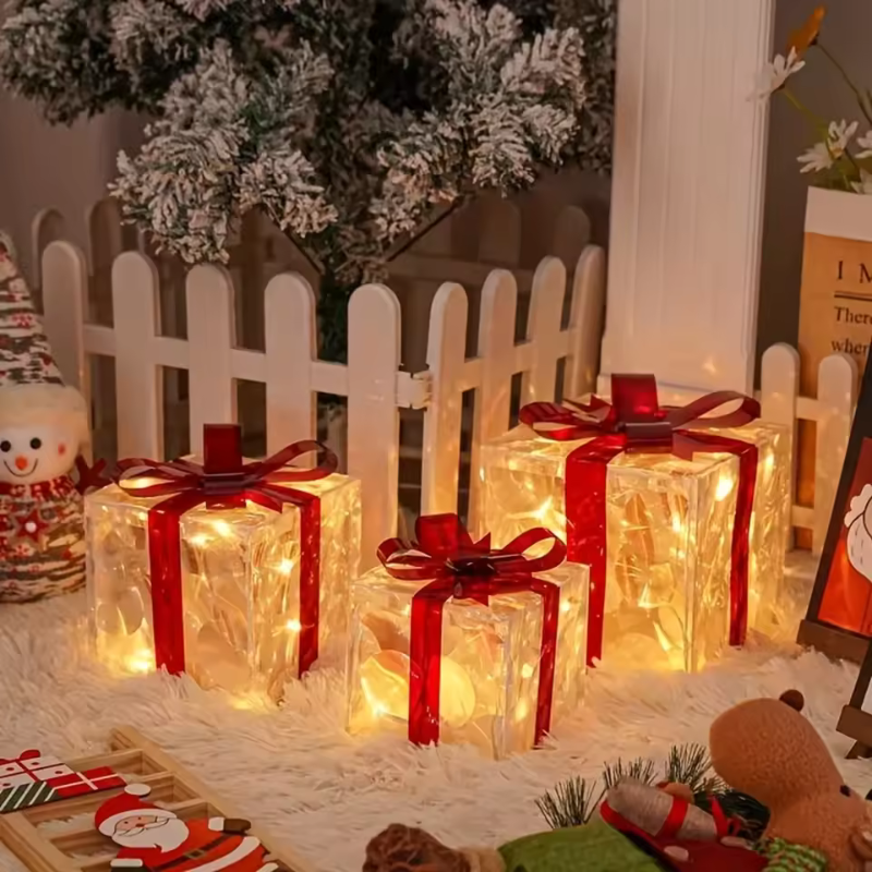 Decorative Christmas lights shaped like gift boxes with red ribbons on a festive background.
