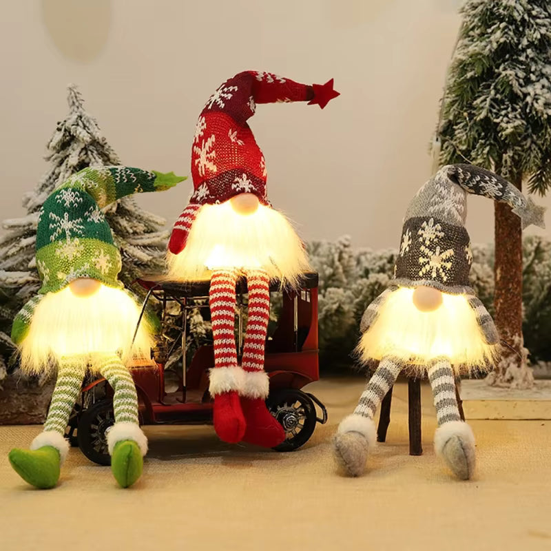 Three animated gnomes with colorful hats and striped socks sitting on a small cart in a snowy landscape.