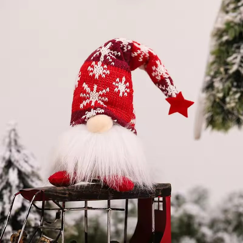 Christmas gnome with red hat and white beard on a snowy background