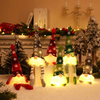 Decorative gnomes with colorful hats and striped socks in a festive setting.