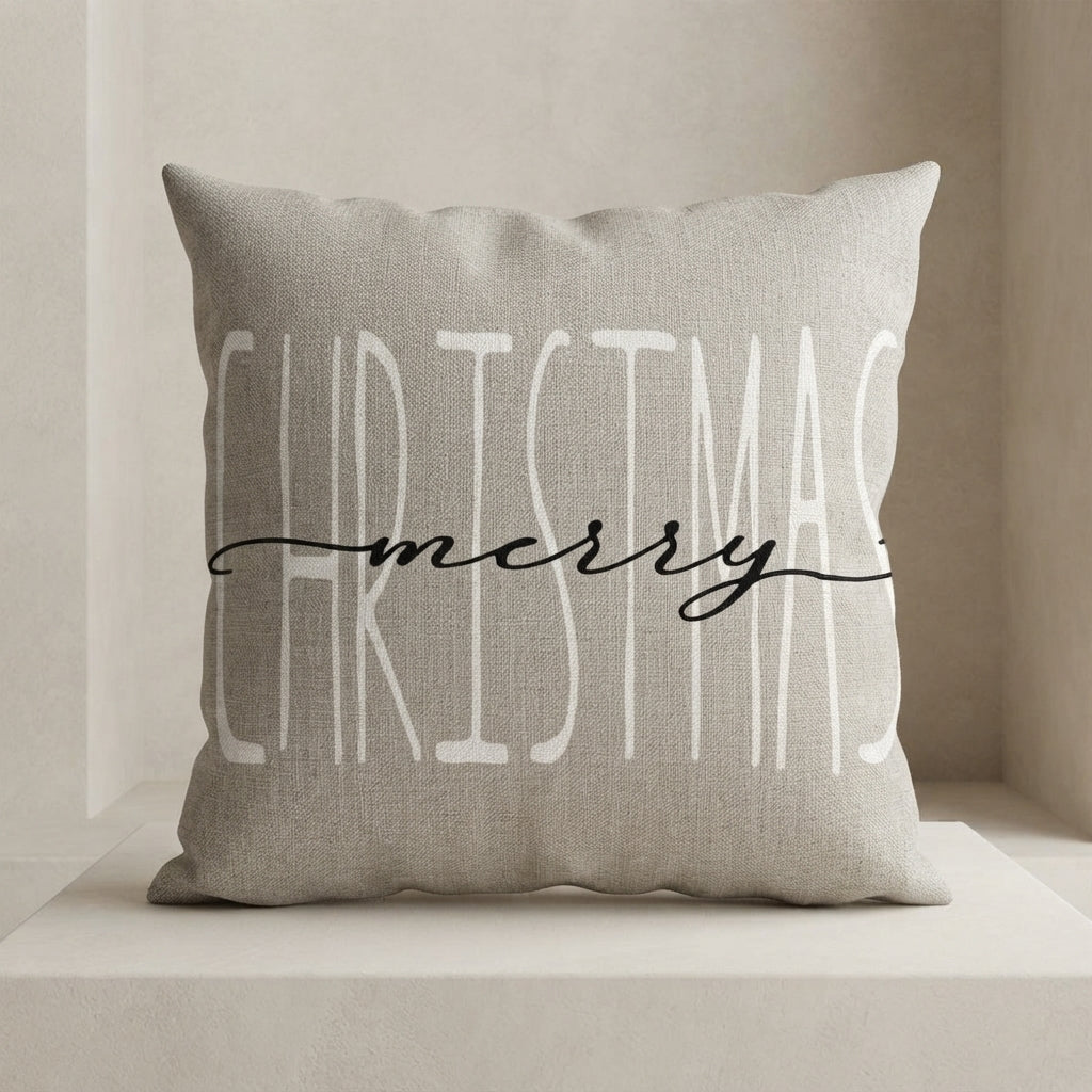 A square throw pillow in a light beige linen fabric with the words 'CHRISTMAS merry' printed on the front in white and black script, resting on a matching beige surface.