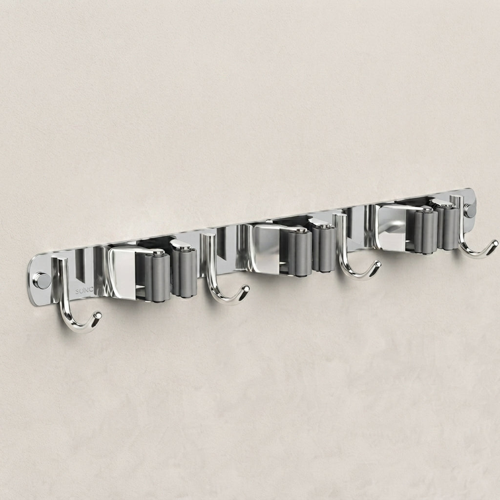 A wall-mounted chrome hook rack with six evenly spaced metal hooks on a light beige textured wall.