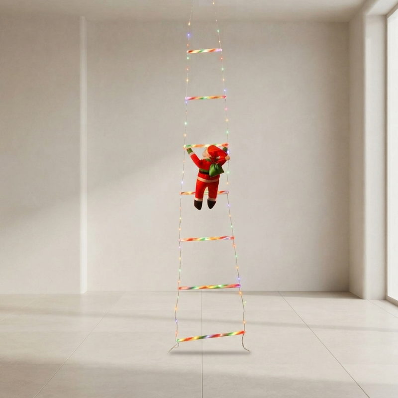 A small Santa Claus figure hangs from a long ladder-like string decoration with multicolored rainbow-striped rungs in a bright, minimal room.