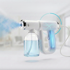 A handheld steam cleaner with a clear water bottle and a blue LED light indicator, shown with a blurred indoor background and mist coming from the nozzle.
