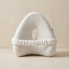 White baby head support pillow on a beige background