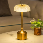 Gold table lamp on a marble surface with a blurred background