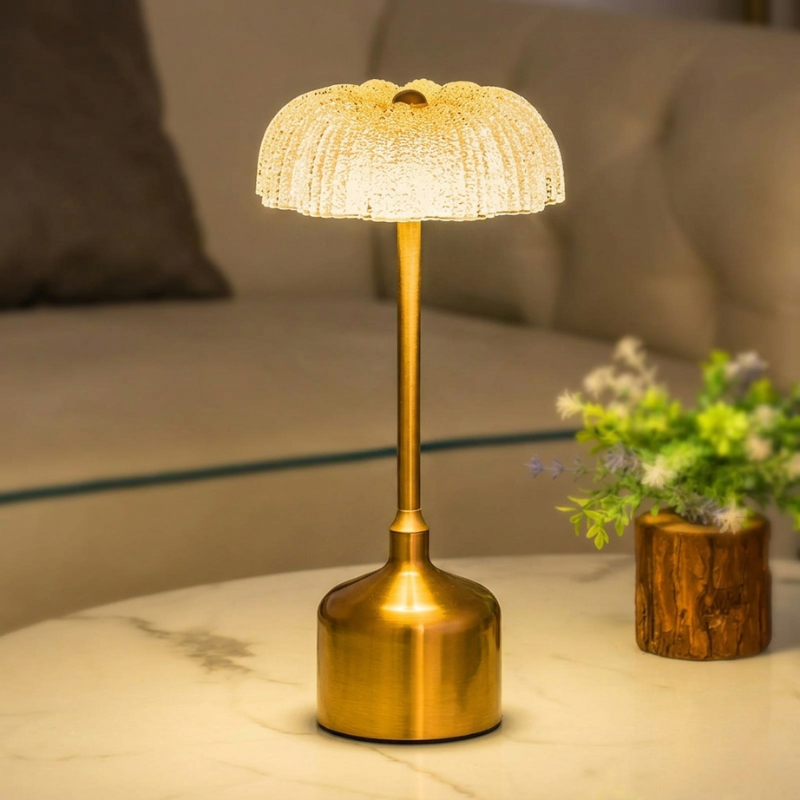 Gold table lamp on a marble surface with a blurred background