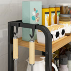 Kitchen shelf with a black and gold kitchen tool holder against a tiled wall.