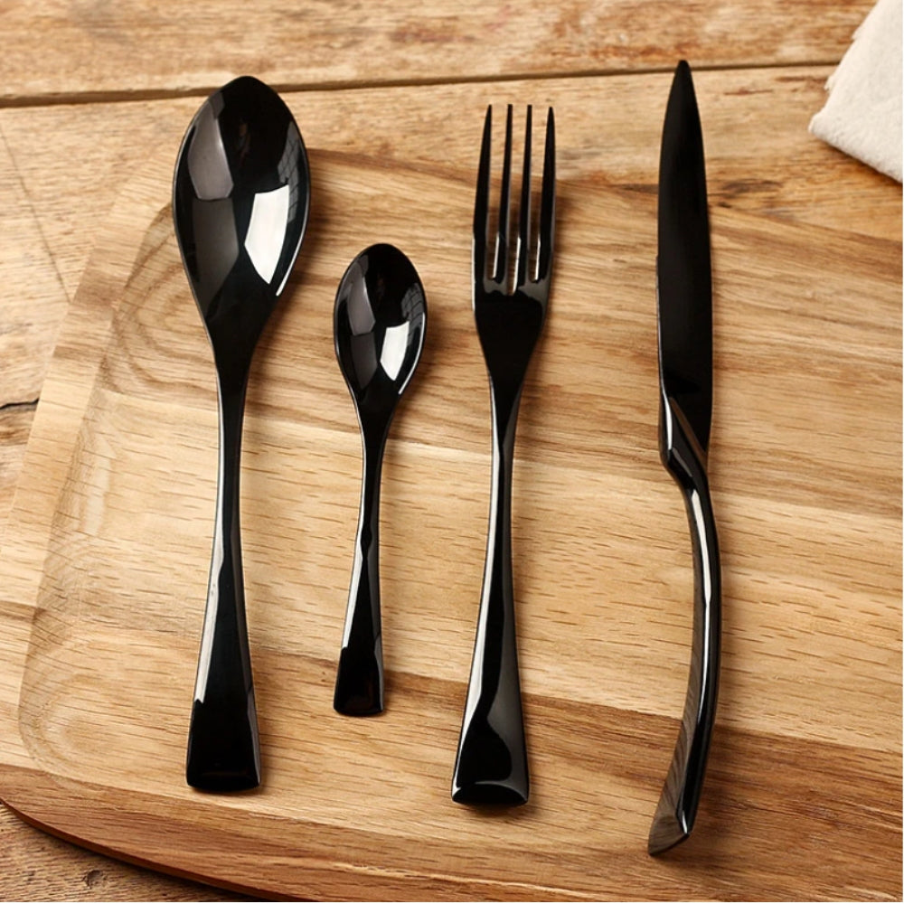 Set of black cutlery including spoon, fork, and knife on a wooden surface