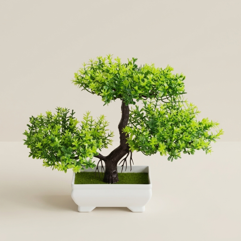 An artificial bonsai-style tree with bright green foliage and a dark brown trunk, displayed in a white rectangular planter on a light beige background.
