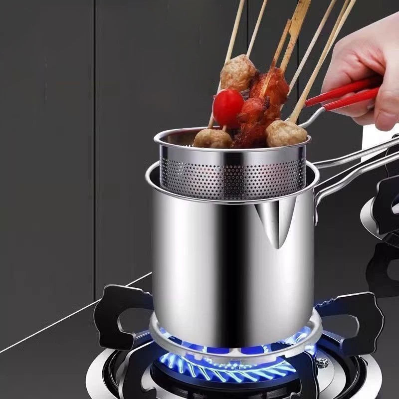 Stainless steel pot on a gas stove with skewered food being cooked.