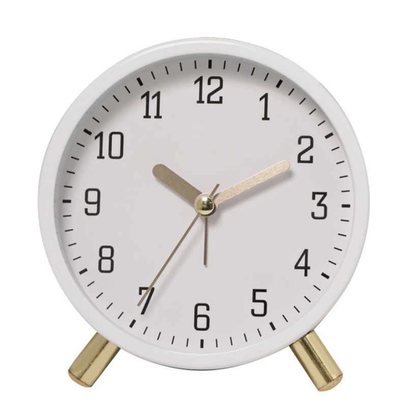 White clock with gold accents on a white background