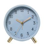 Light blue alarm clock with gold accents on a white background