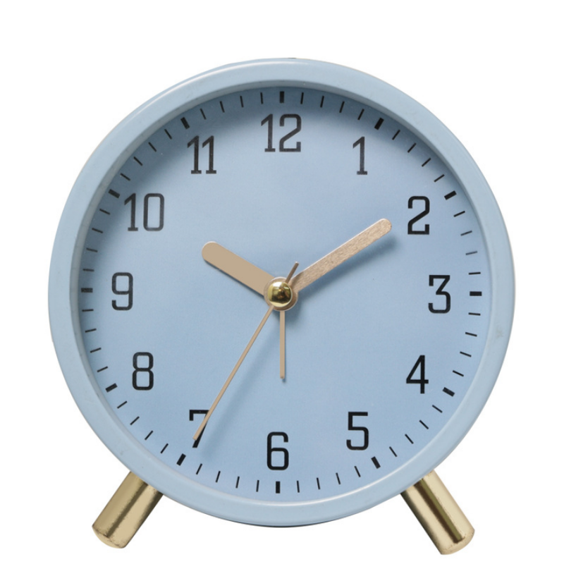 Light blue alarm clock with gold accents on a white background