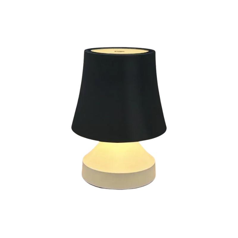 Table lamp with black shade and beige base on a white background
