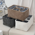 Three storage baskets in brown, gray, and white on a sofa.