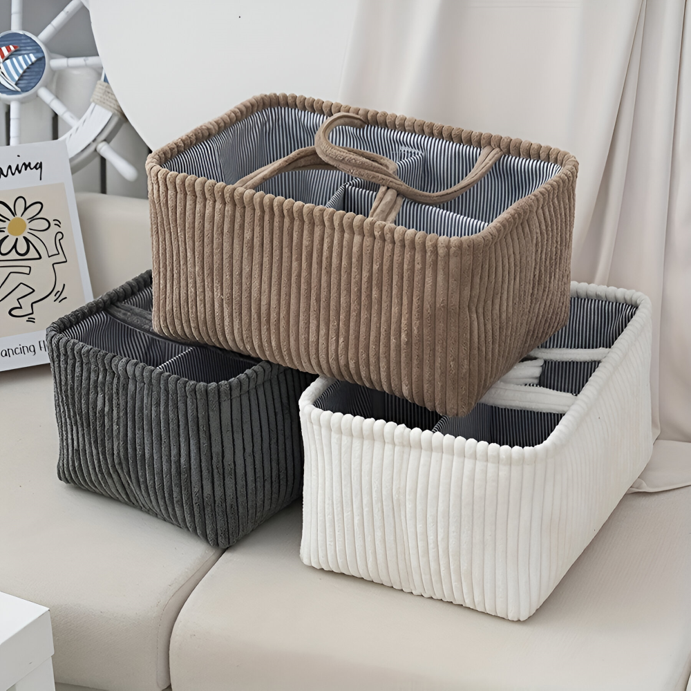 Three storage baskets in brown, gray, and white on a sofa.