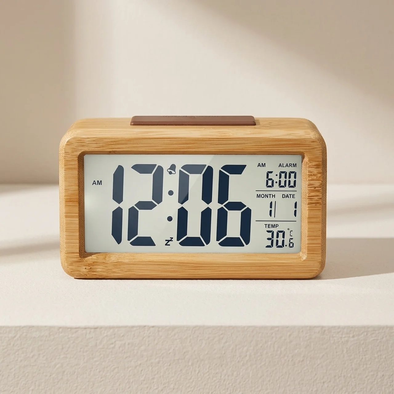 Digital clock with wooden frame on a beige surface