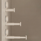 Three white plastic door stoppers with circular suction cups mounted on a beige door, shown against a matching beige background.