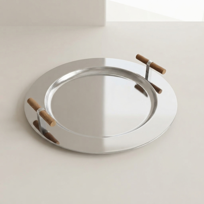 Silver tray with wooden handles on a light background
