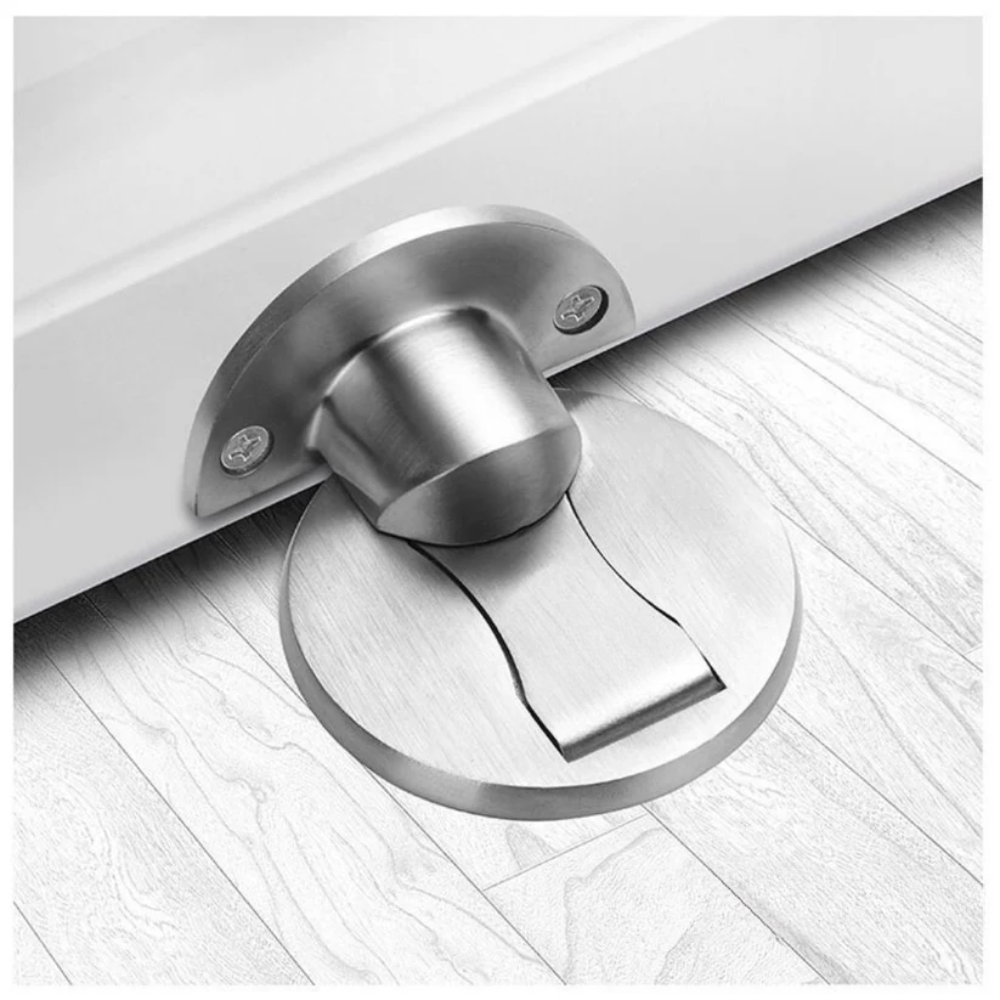Metallic door stopper on a wooden floor