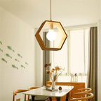 Modern dining room with geometric pendant light, table, chairs, and decorative elements.