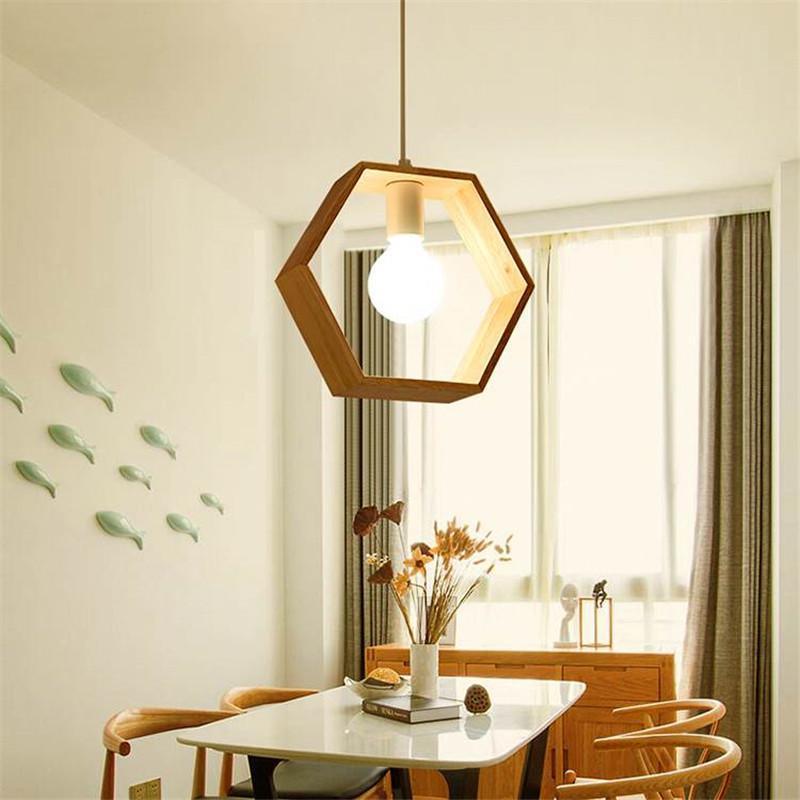 Modern dining room with geometric pendant light, table, chairs, and decorative elements.
