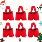 Six pairs of red Santa-themed shorts with faux fur trim and black faux-leather belts, arranged in a 3x2 grid on a white background with Christmas-themed cartoon decorations around the edges.