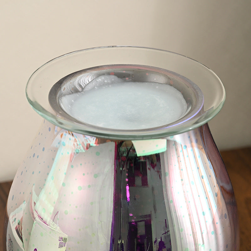 Glass diffuser with a metallic top on a white background
