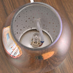 Close-up of a lamp with a bulb inside on a wooden surface