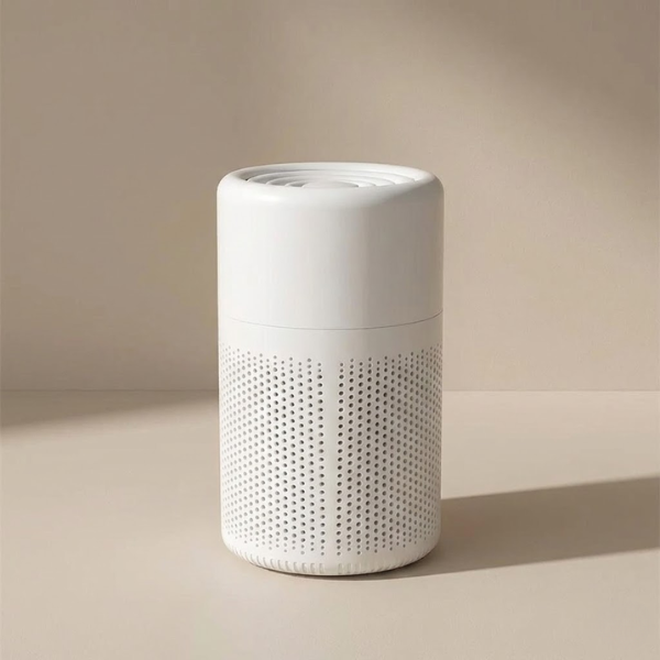 White cylindrical air purifier on a beige background