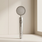 Handheld shower head on a neutral background