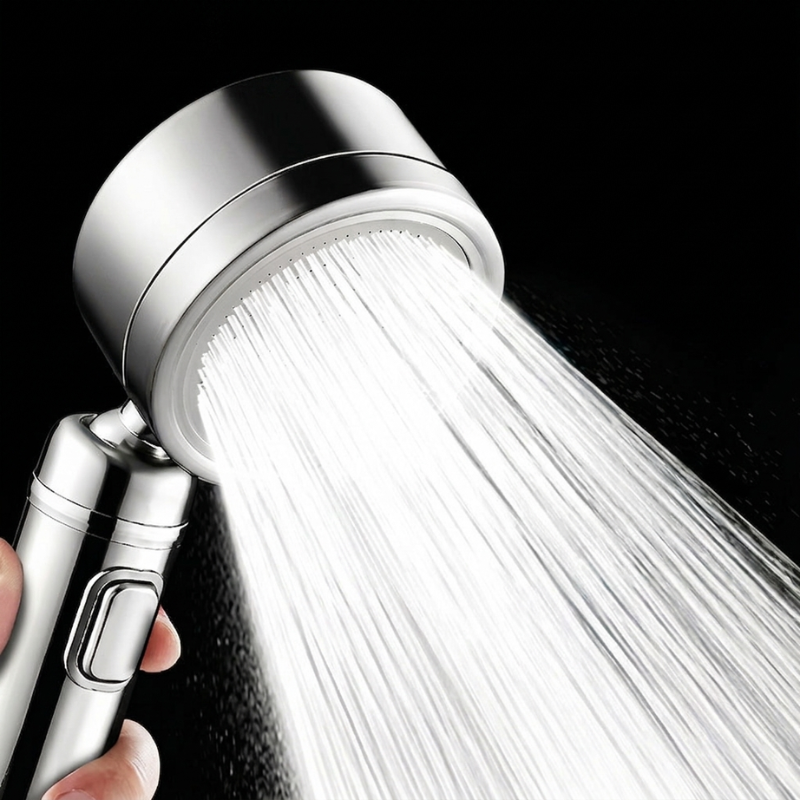 Chrome shower head with water flowing against a black background