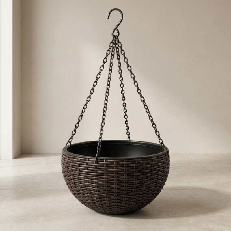 Black hanging planter with wicker design on a neutral background