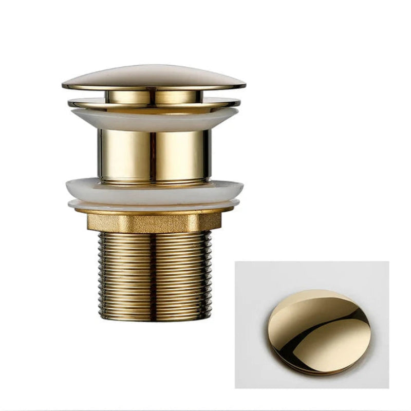 Gold-colored drain plug without overflow on a white background