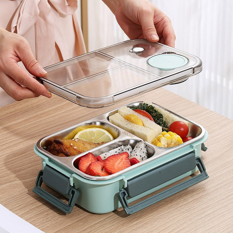 Bento box with compartments filled with food on a wooden surface