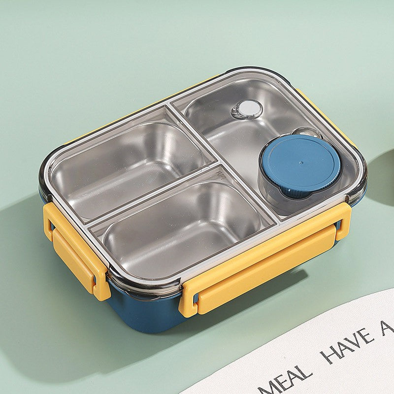 Stainless steel bento box with yellow base and blue lid on a light green background