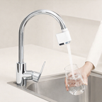 Chrome kitchen faucet with a water filter being used to fill a glass.