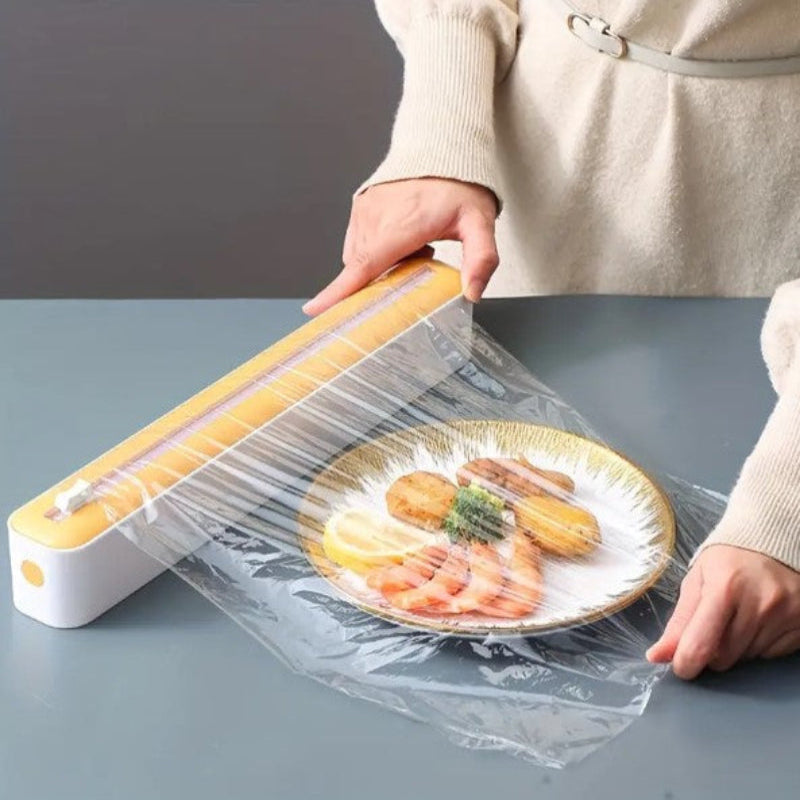 Person using a food vacuum sealer to seal a plate of food on a gray surface.