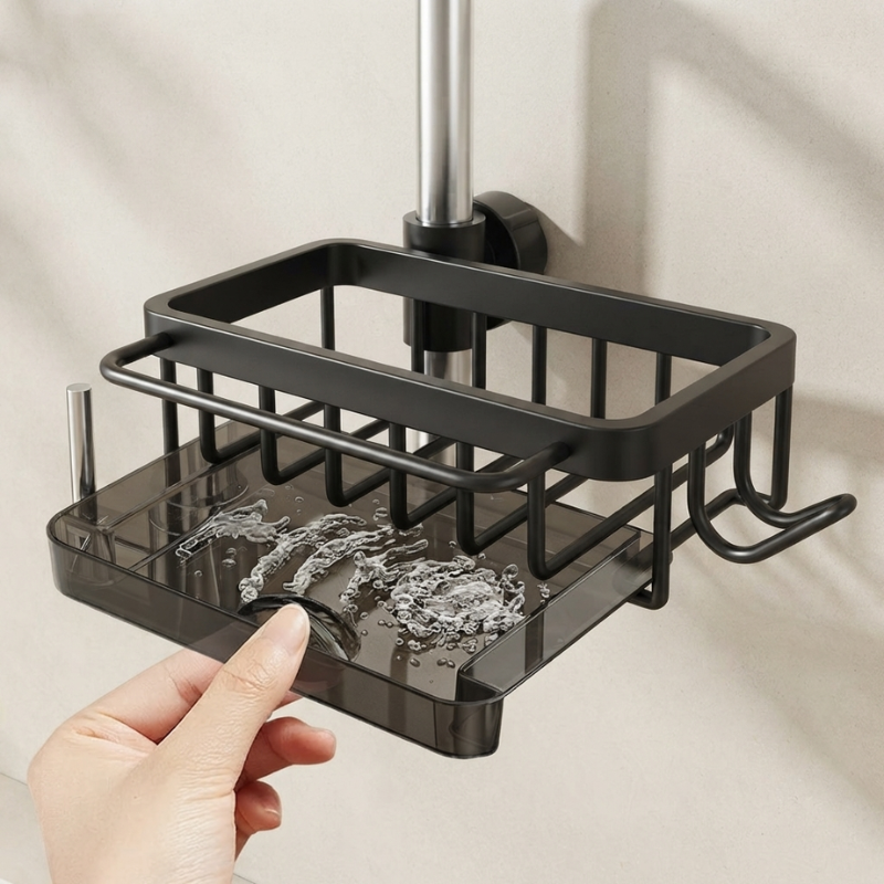 Black shower caddy with soap dish held by a hand against a neutral background