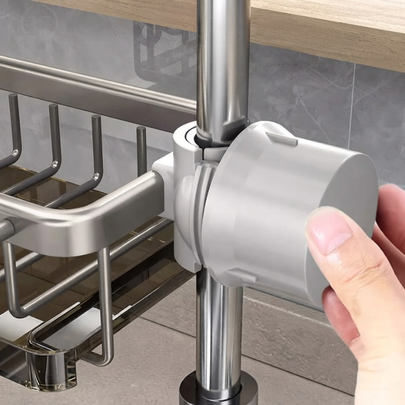 Hand holding a gray kitchen tool under a metal rack