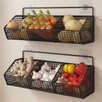 Two black wire wall baskets filled with vegetables on a white wall.