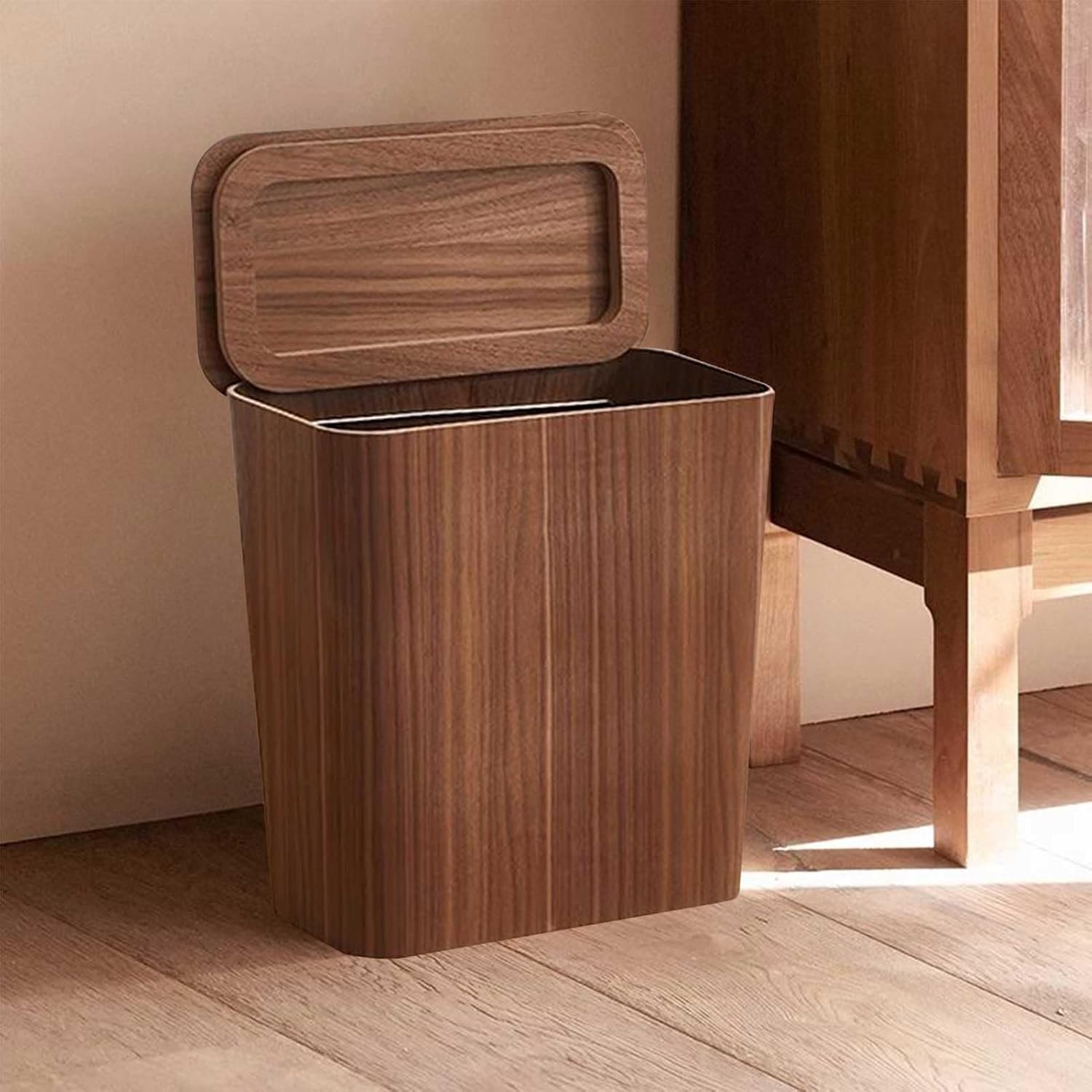 Wooden trash bin with a lid on a wooden floor.
