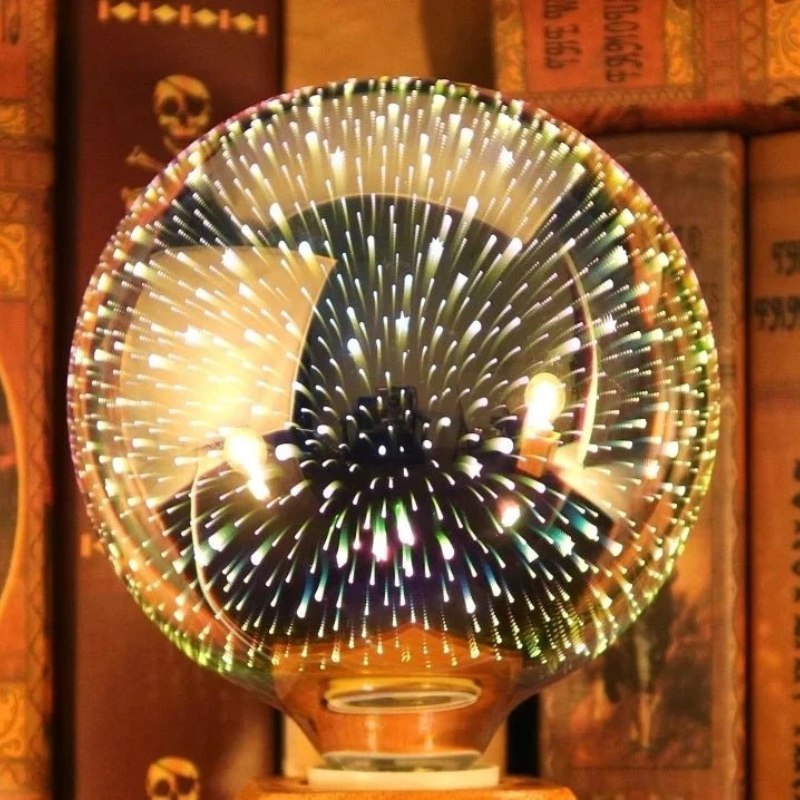 A clear glass fiber optic globe lamp on a wooden base, glowing with many small light points, set against a background of warm, vintage books.